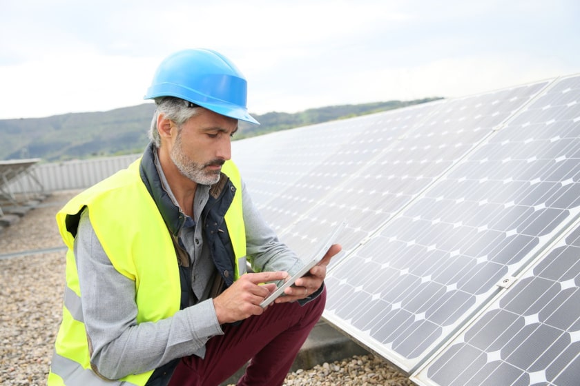 Engineer inspecting solar panels