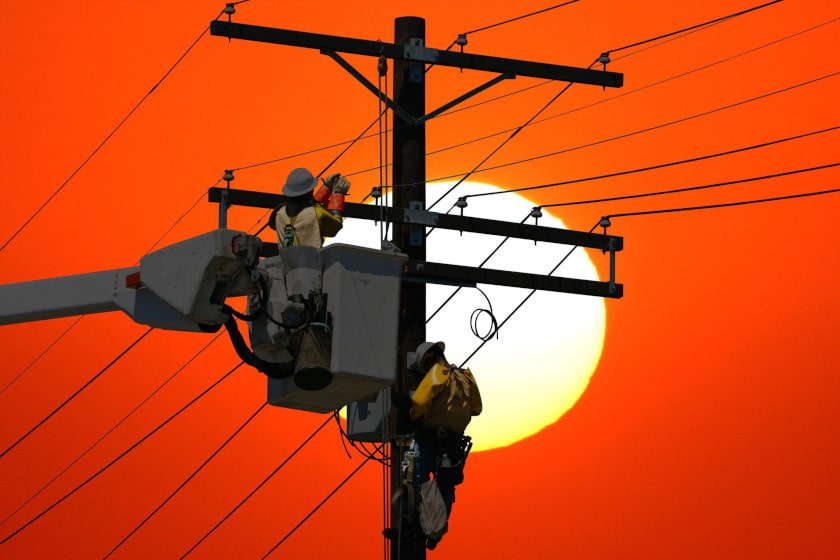 Utility workers on a power pole