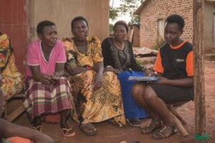 An African woman shares during a group talk therapy session