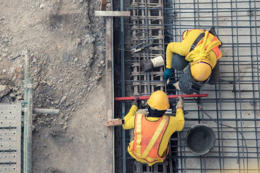 workers using construction technology for building foundation