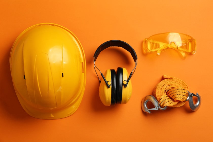 safety equipment used in OSHA compliance inspections on orange backdrop