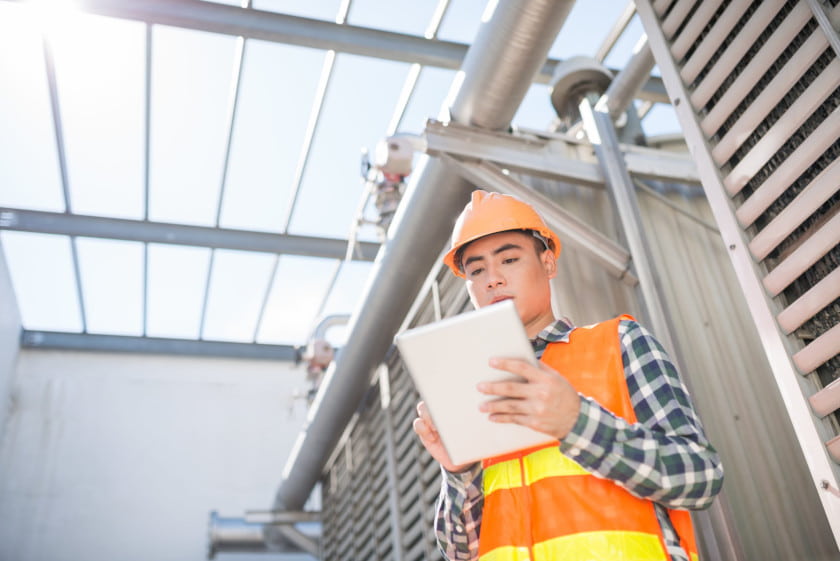 male construction worker completing a mobile form on a tablet