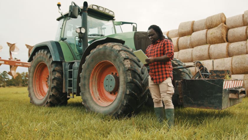 Farmer completes equipment inspection checklist on his mobile device