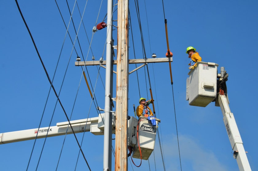 Power workers on a utility pole