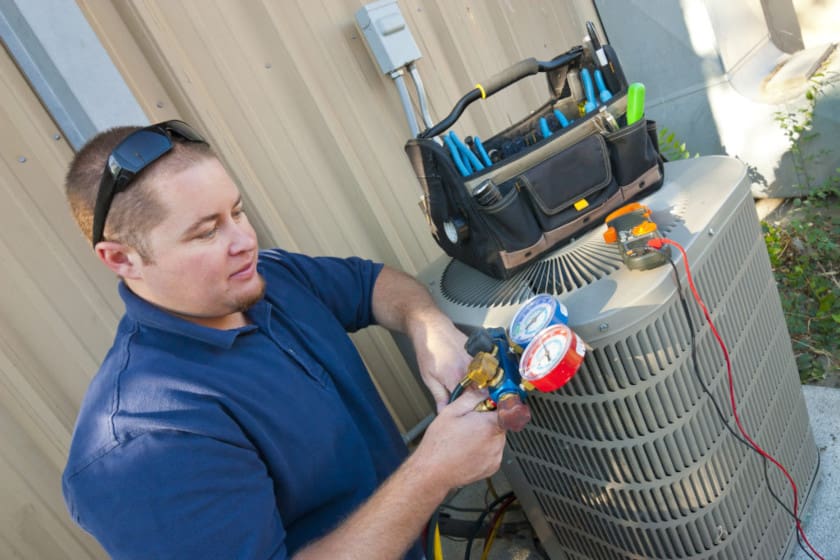 HVAC service technician performs a unit inspection