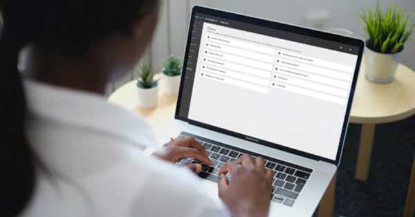 Woman accessing work orders from computer browser.